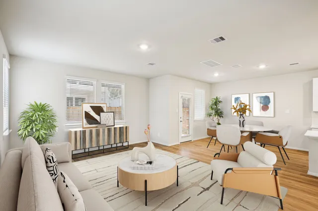 a living room with furniture and a potted plant