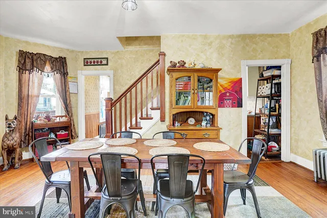 a view of a dining room with furniture and a potted plant