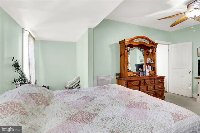 a bedroom with a bed and a dresser in it