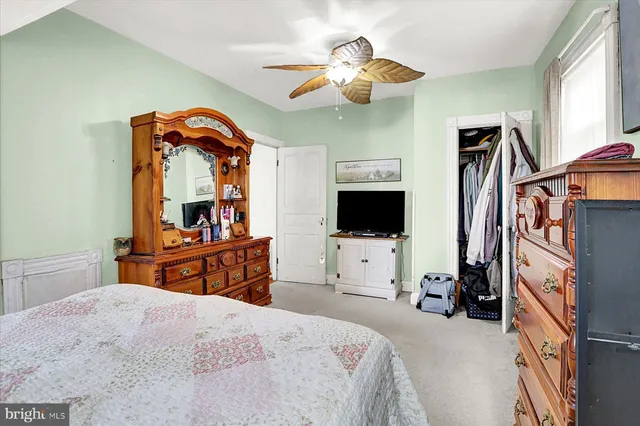 a bedroom with furniture and a flat screen tv