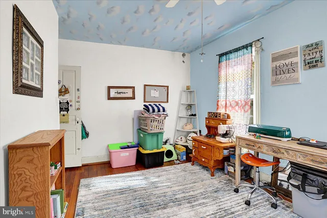 a bedroom with furniture and a potted plant