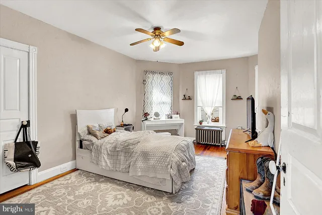 a bedroom with bed and a chandelier
