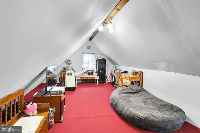 a room with lots of white furniture and a chandelier