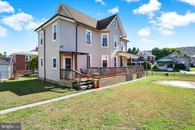 a view of a house with a yard patio and sitting area