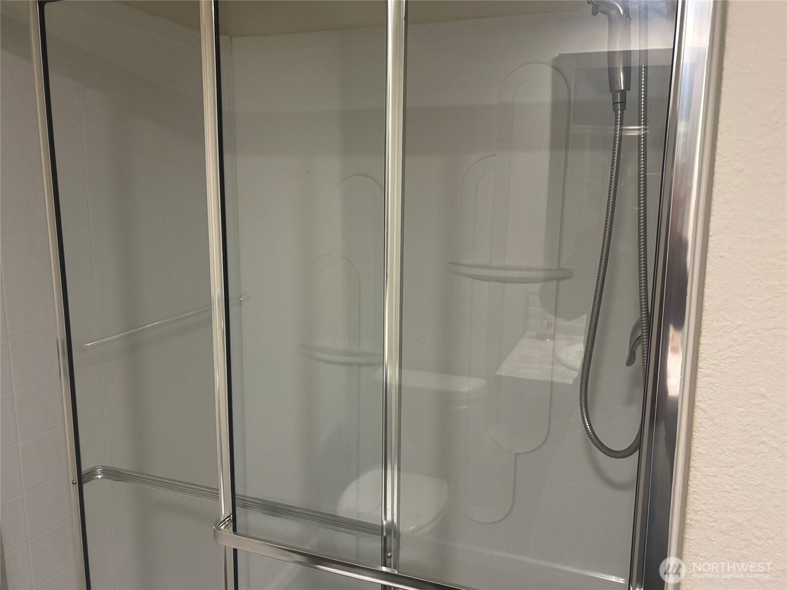 45182 Kimta Loop, Unit 3B84 Concrete, WA 98237 - Photo 12 of 37 a bathroom with a glass shower door