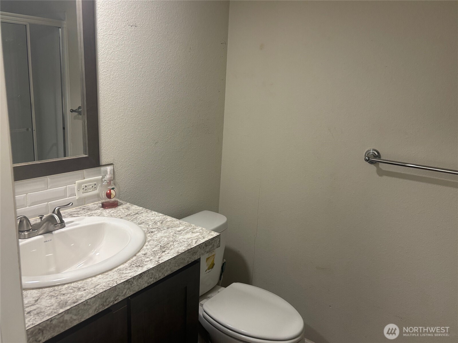 45182 Kimta Loop, Unit 3B84 Concrete, WA 98237 - Photo 13 of 37 a bathroom with a granite countertop toilet sink and mirror
