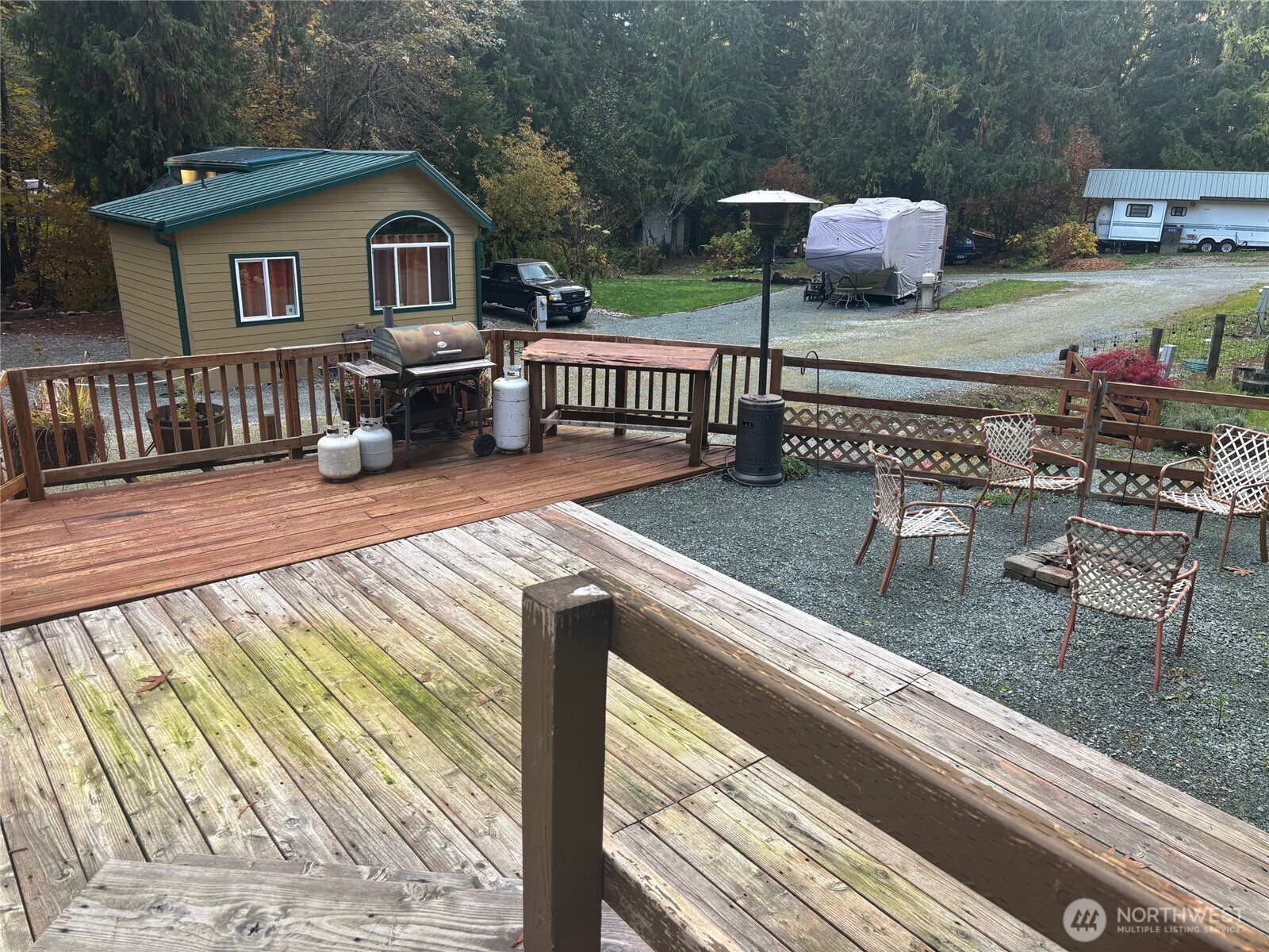45182 Kimta Loop, Unit 3B84 Concrete, WA 98237 - Photo 17 of 37 a view of house with deck outdoor seating and covered with trees
