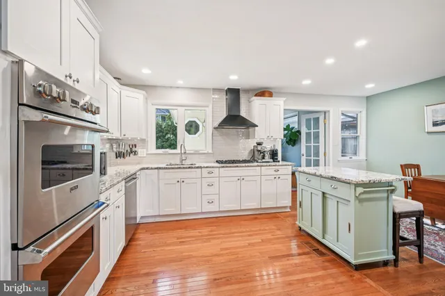 a kitchen with stainless steel appliances granite countertop a stove and a sink
