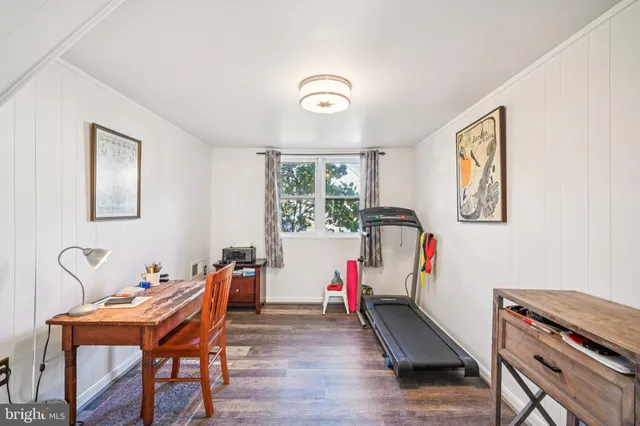 a hallway with furniture and wooden floor