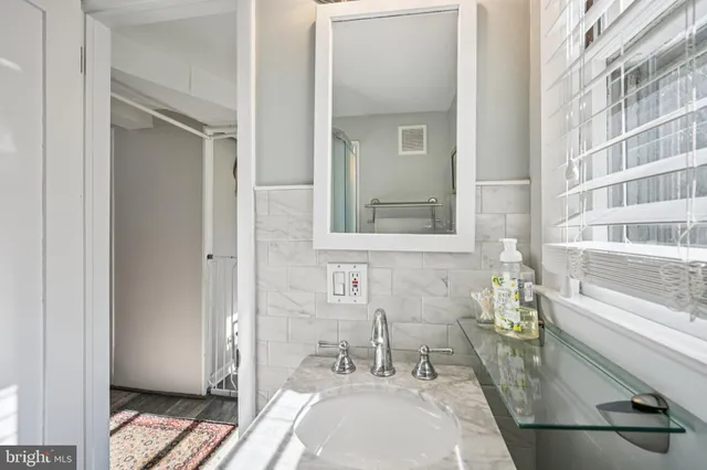 a bathroom with a sink and a mirror