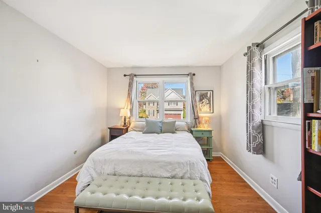 a bed sitting in a bedroom next to a window