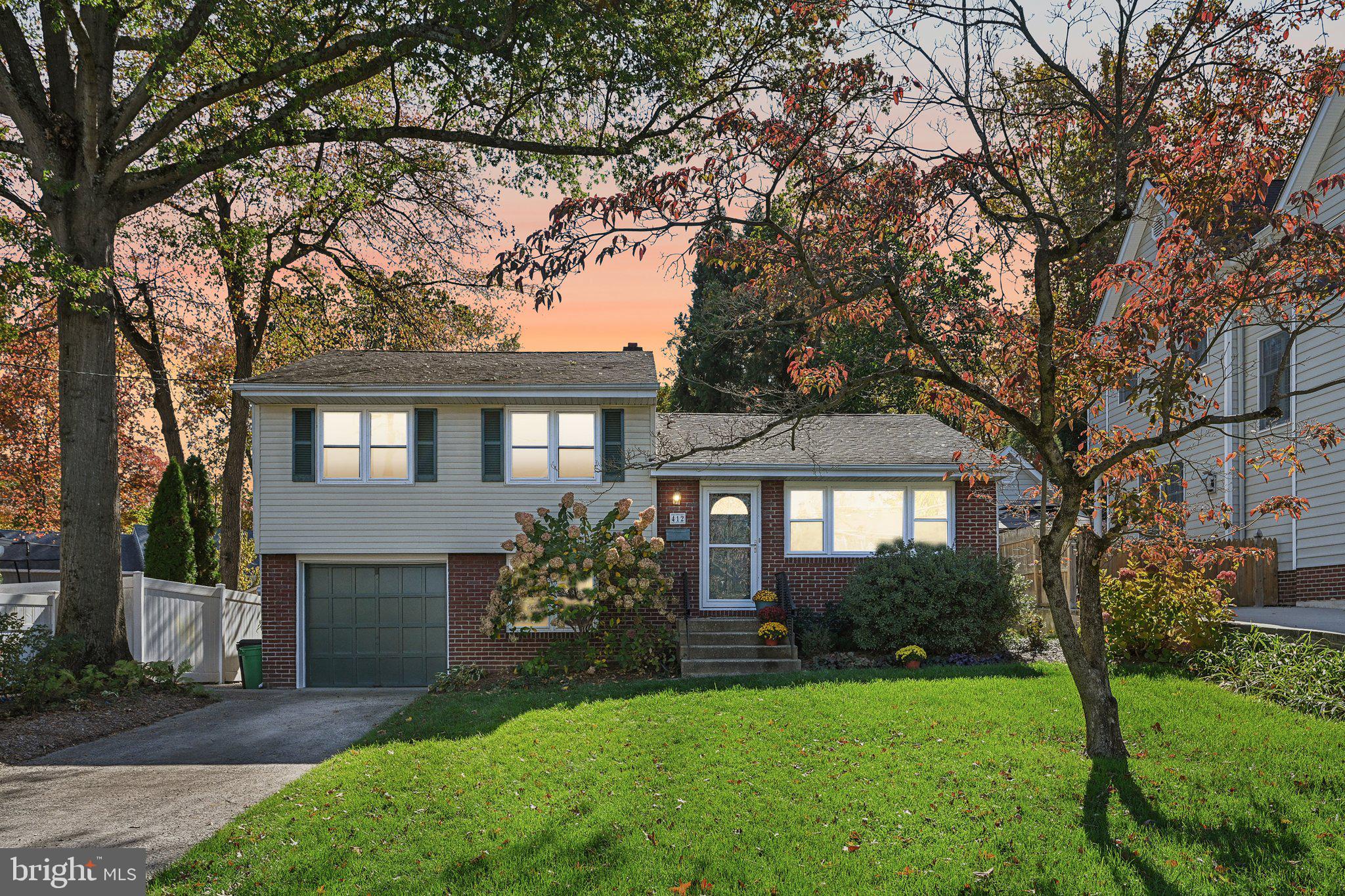 412 East Summit Avenue Haddonfield, NJ 08033 - Photo 3 of 35 a front view of a house with a garden