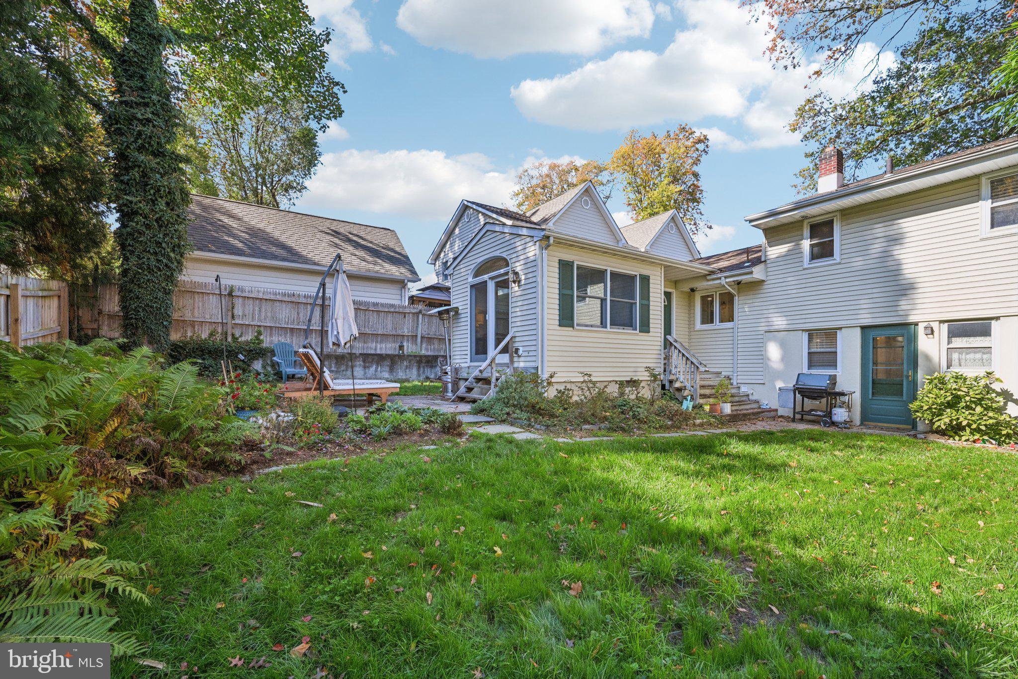 412 East Summit Avenue Haddonfield, NJ 08033 - Photo 31 of 35 a front view of a house with a garden and trees