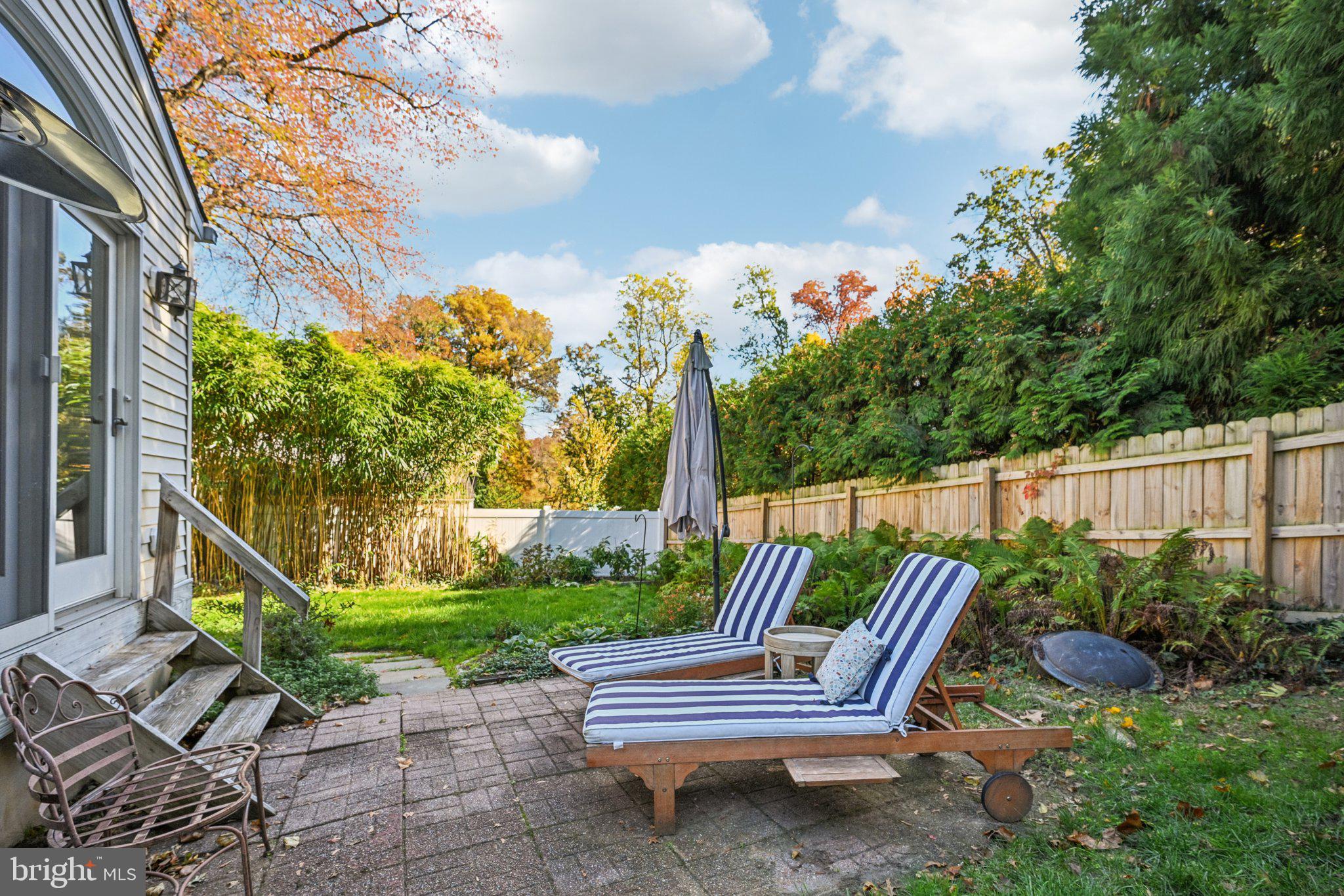 412 East Summit Avenue Haddonfield, NJ 08033 - Photo 34 of 35 a view of a chair and tables in the backyard with wooden fence