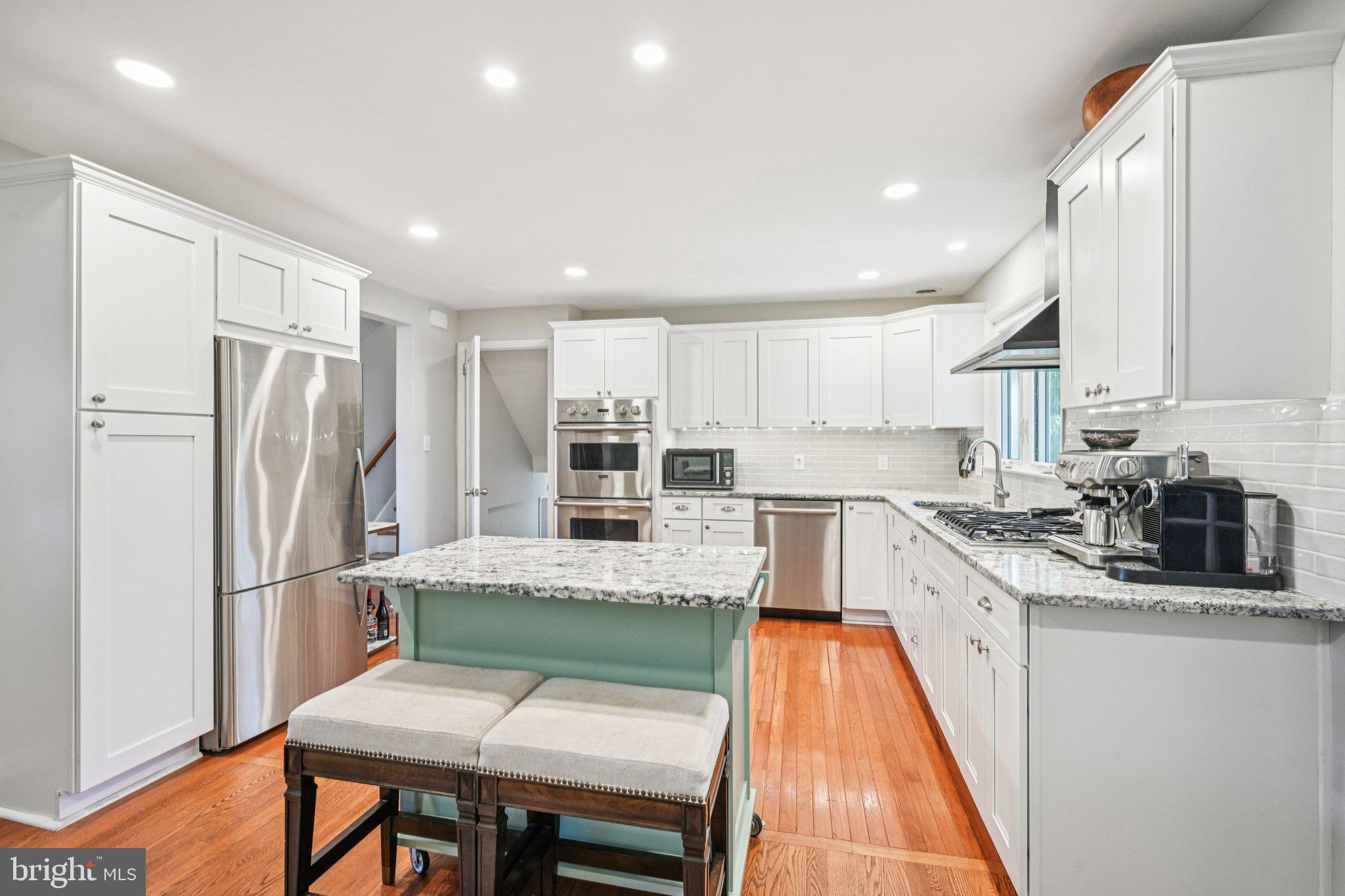 412 East Summit Avenue Haddonfield, NJ 08033 - Photo 9 of 35 a kitchen with stainless steel appliances granite countertop a refrigerator sink and wooden cabinets