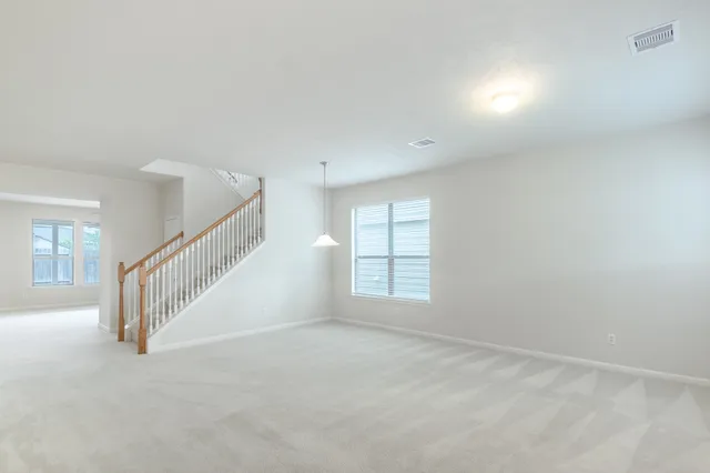 a view of an empty room with stairs