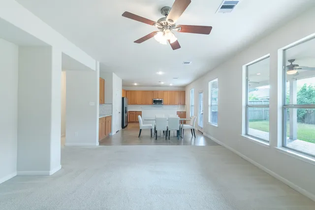 a view of a livingroom with furniture ceiling fan and window