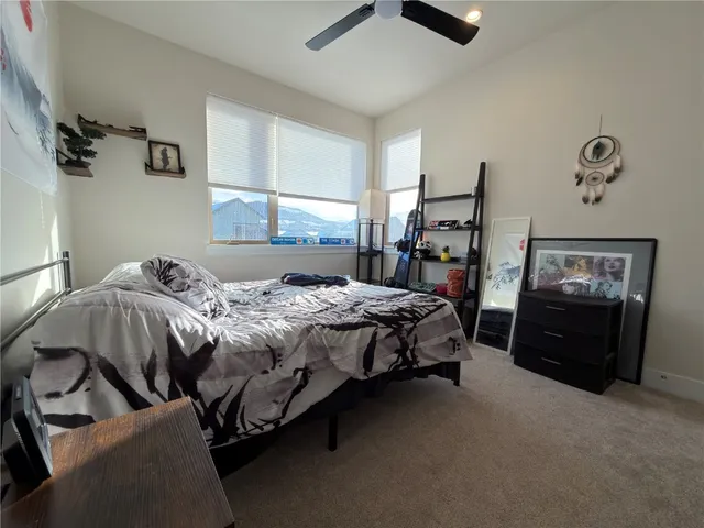 a bedroom with a bed and a tv