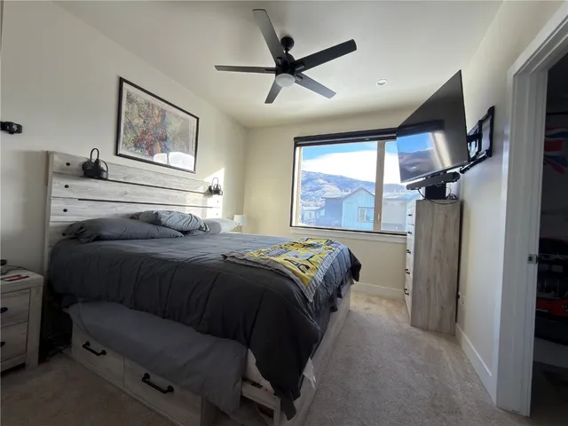 a bedroom with a bed and a television