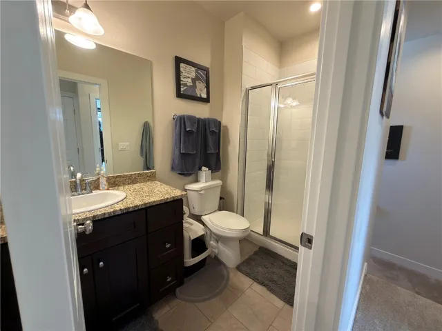 a bathroom with a toilet sink shower and mirror