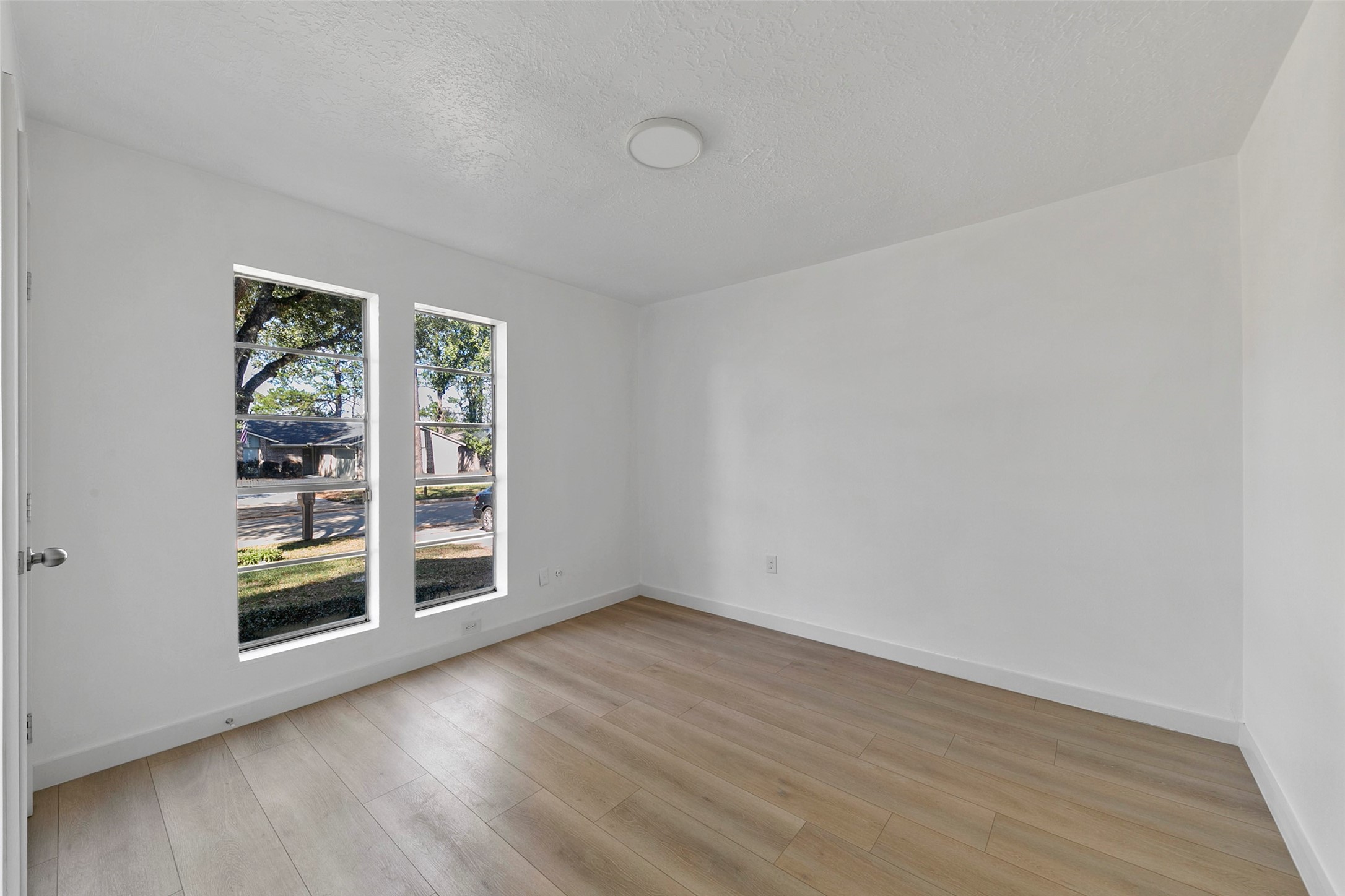 2042 Lexington Woods Drive Spring, TX 77373 - Photo 20 of 32 wooden floor in an empty room with a window