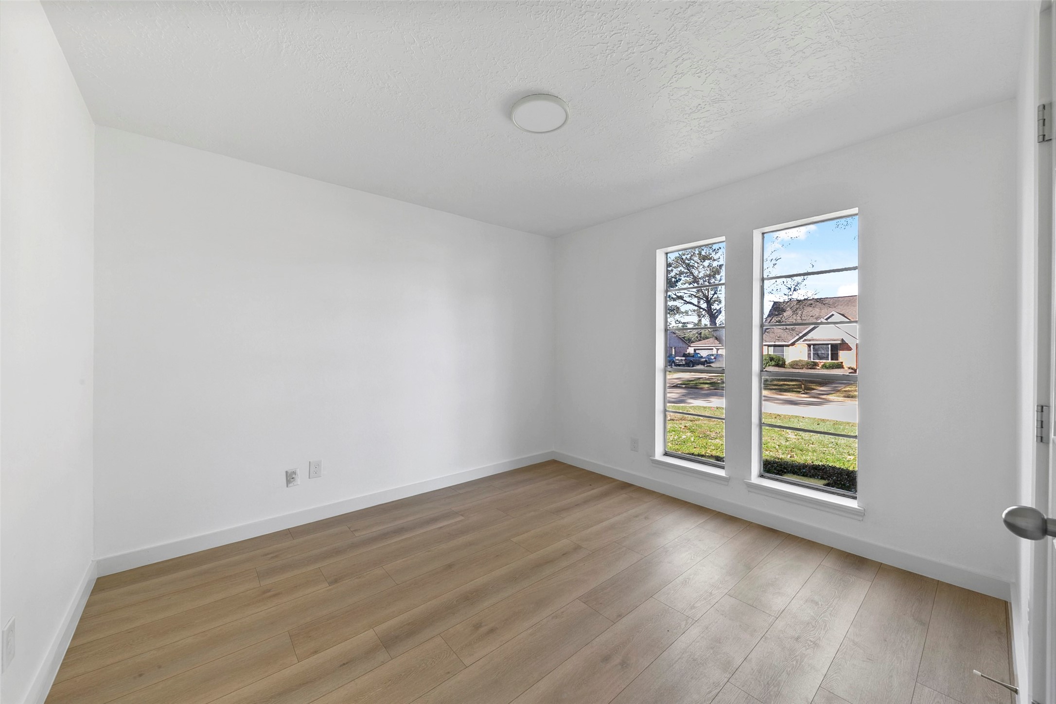 2042 Lexington Woods Drive Spring, TX 77373 - Photo 22 of 32 an empty room with wooden floor and windows