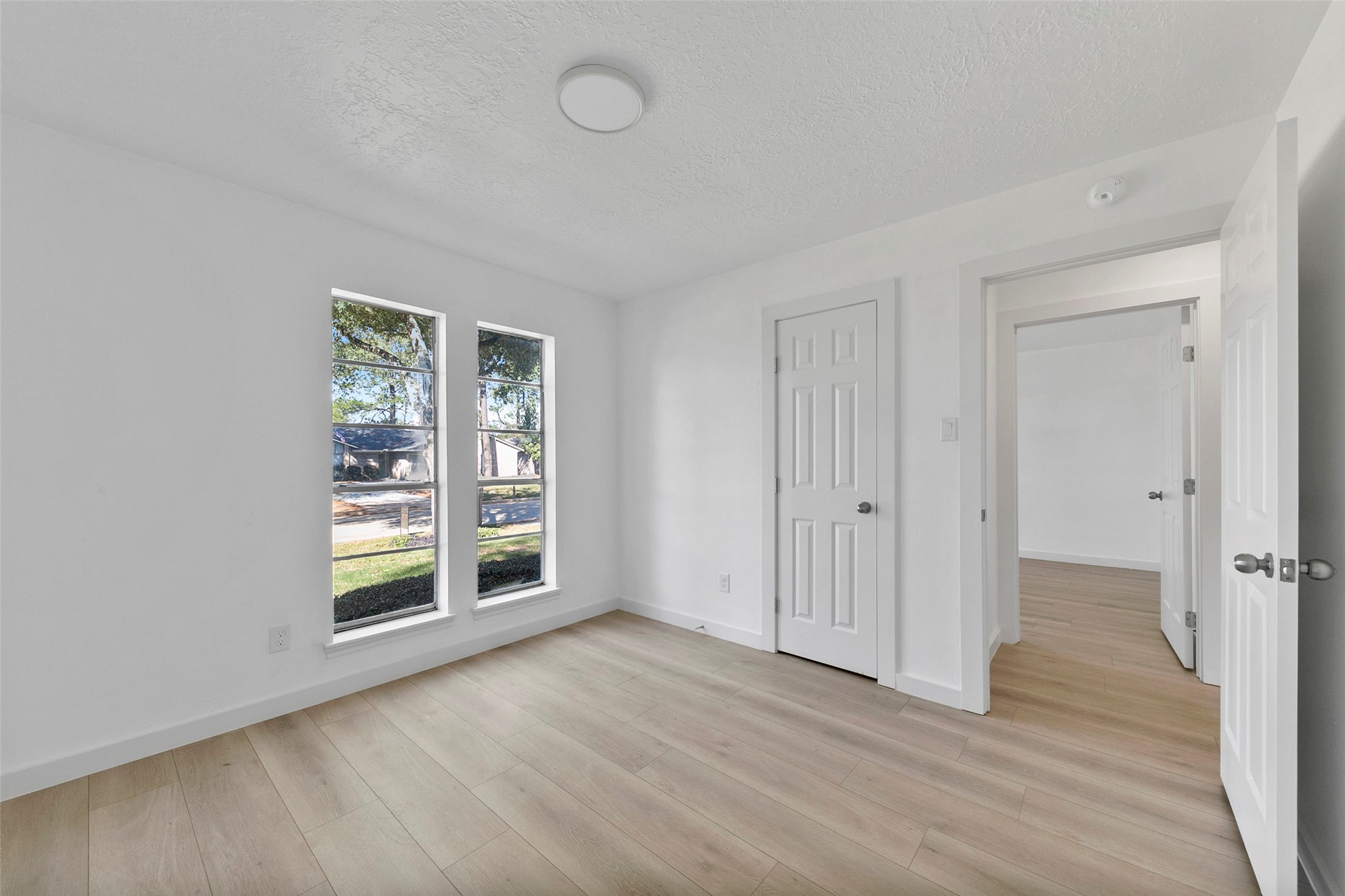 2042 Lexington Woods Drive Spring, TX 77373 - Photo 23 of 32 an empty room with wooden floor and windows