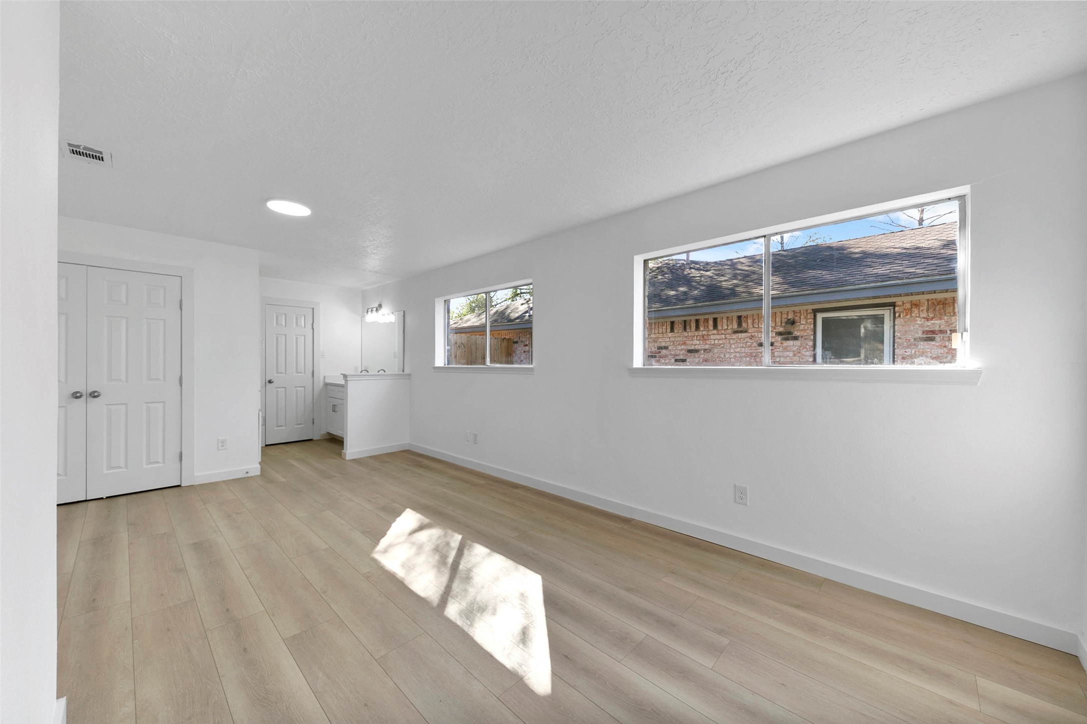 2042 Lexington Woods Drive Spring, TX 77373 - Photo 24 of 32 a view of an empty room with wooden floor and a window