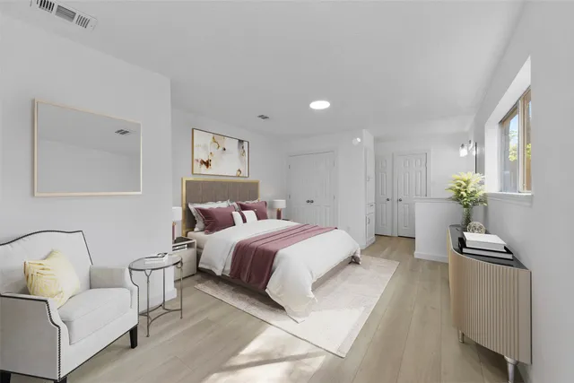 a spacious bedroom with a bed and a couch