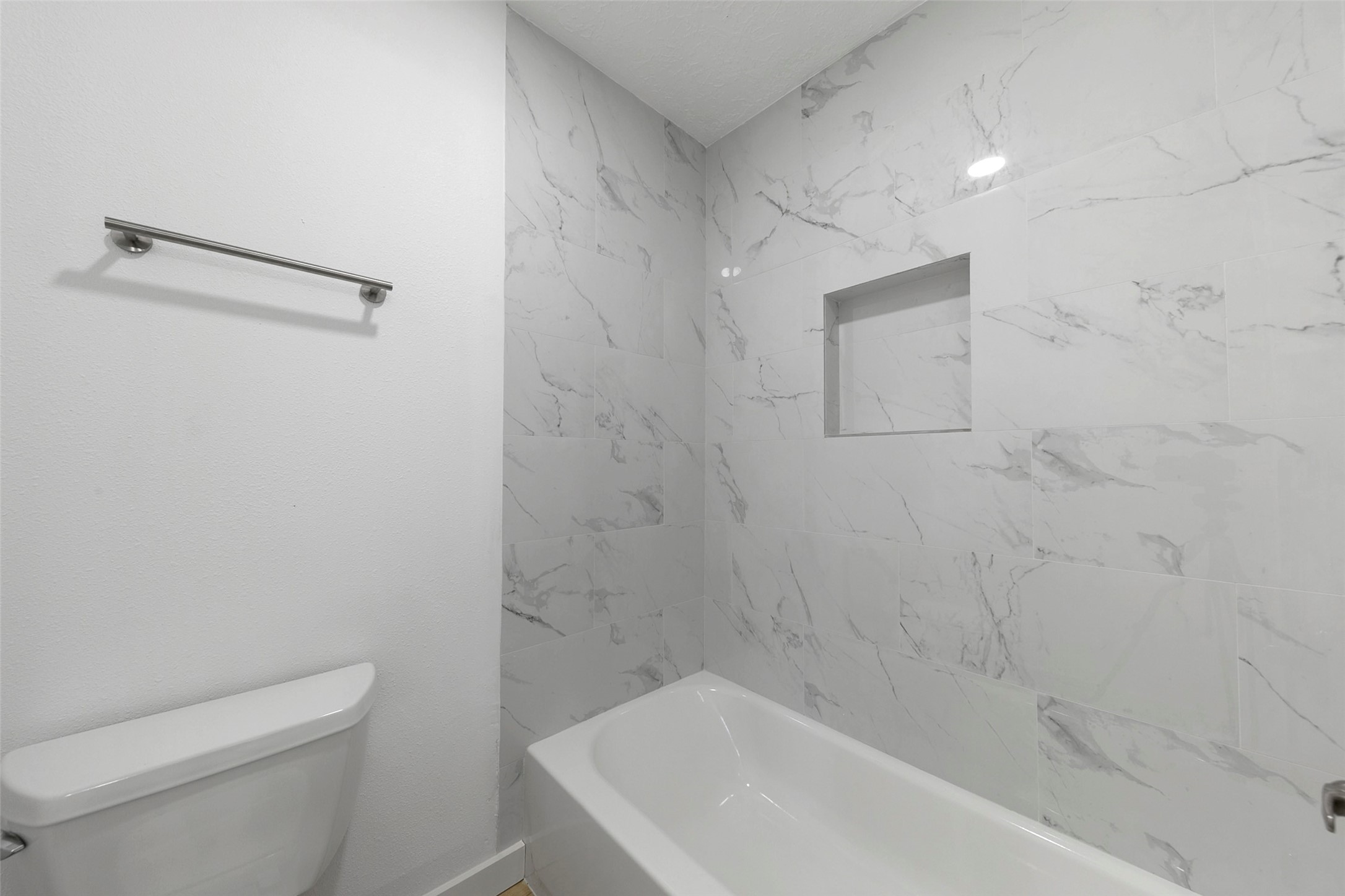 2042 Lexington Woods Drive Spring, TX 77373 - Photo 29 of 32 a bath tub sitting next to a white toilet and a shower