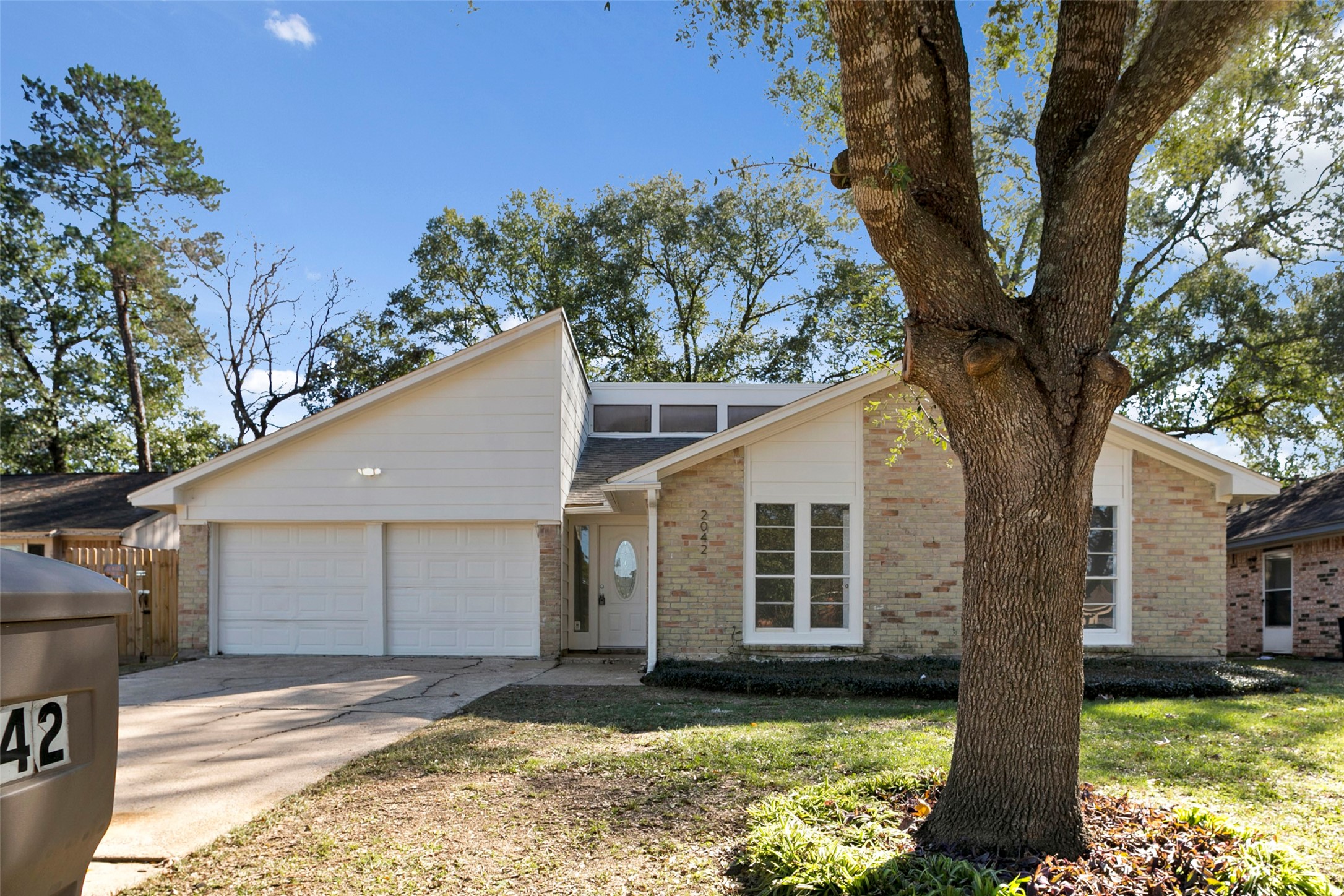 2042 Lexington Woods Drive Spring, TX 77373 - Photo 4 of 32 a view of a house with a tree in the backyard