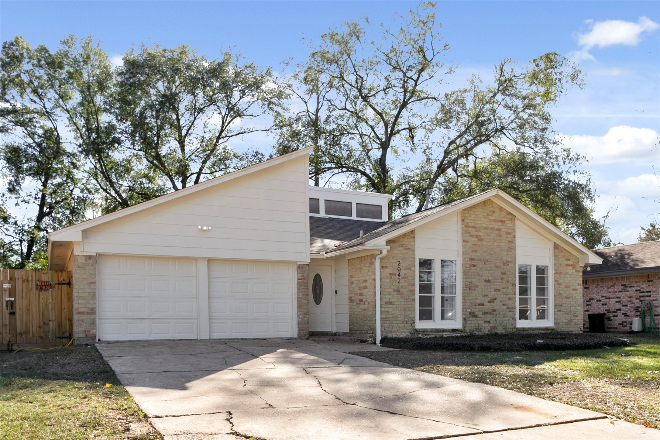 2042 Lexington Woods Drive Spring, TX 77373 - Photo 7 of 32 a front view of a house with a yard