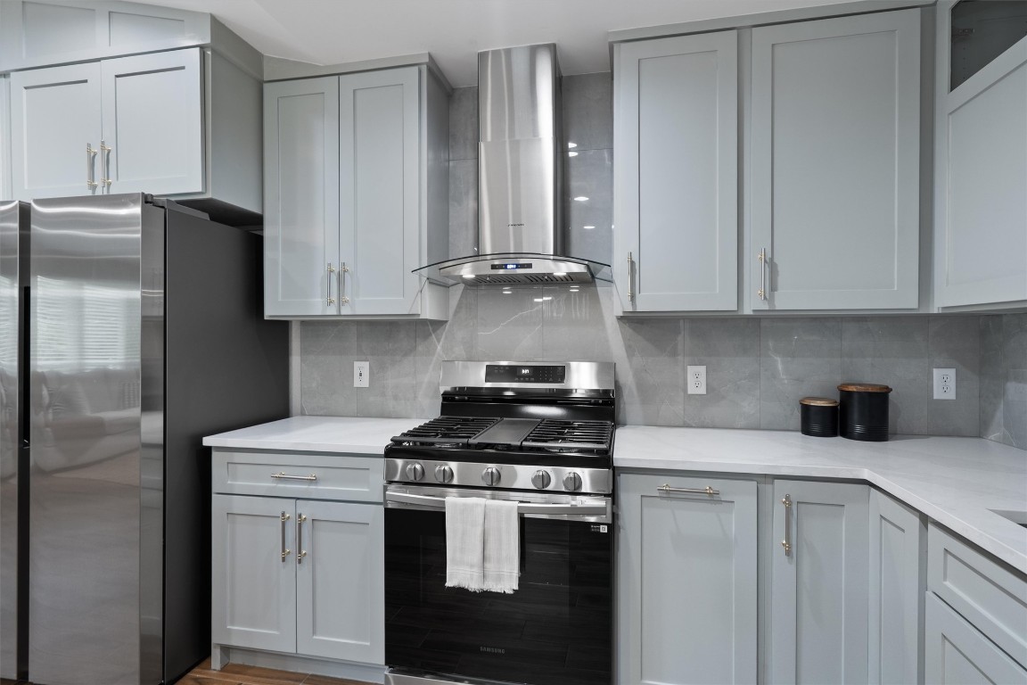 803 Glen Road Austin, TX 78753 - Photo 11 of 35 a kitchen with stainless steel appliances granite countertop a stove a refrigerator and a cabinets