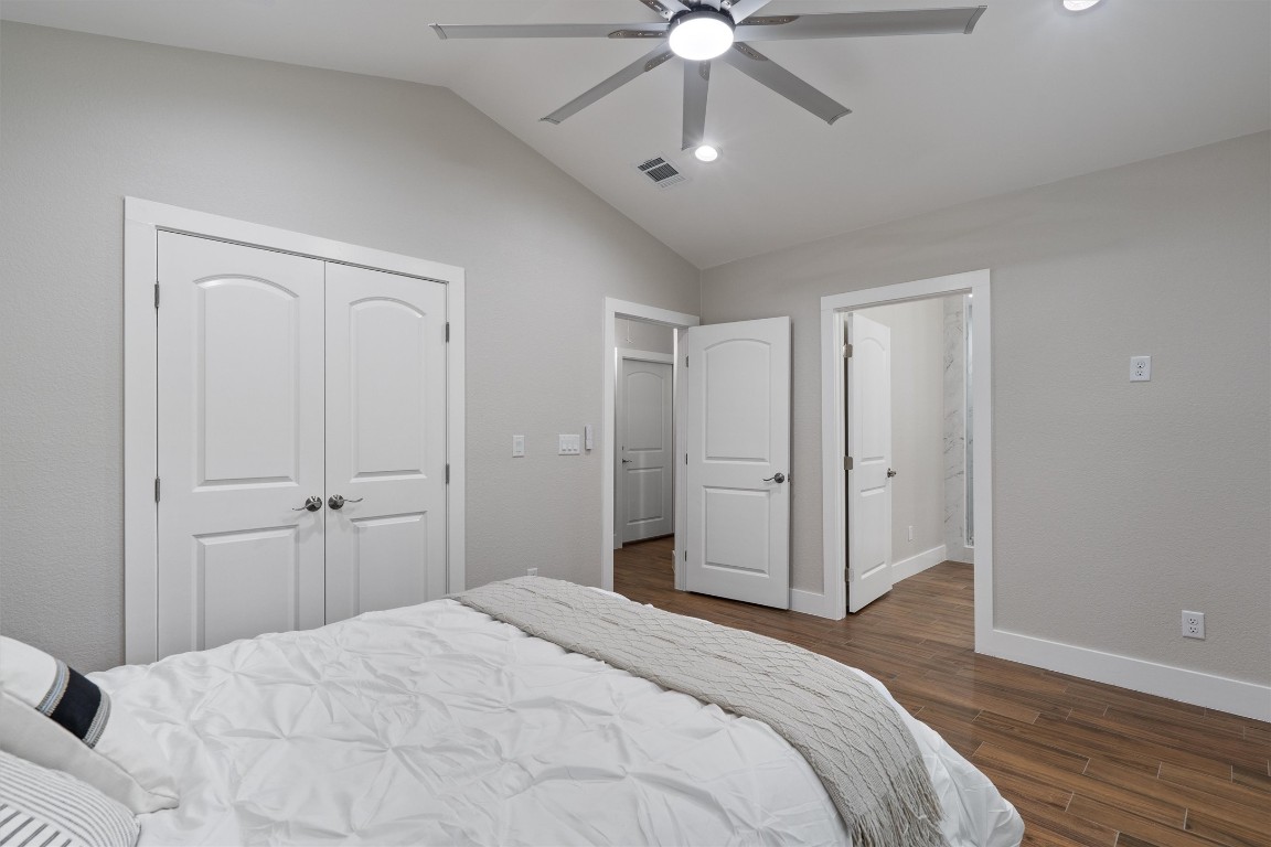 803 Glen Road Austin, TX 78753 - Photo 14 of 35 a bedroom with a bed and a chandelier