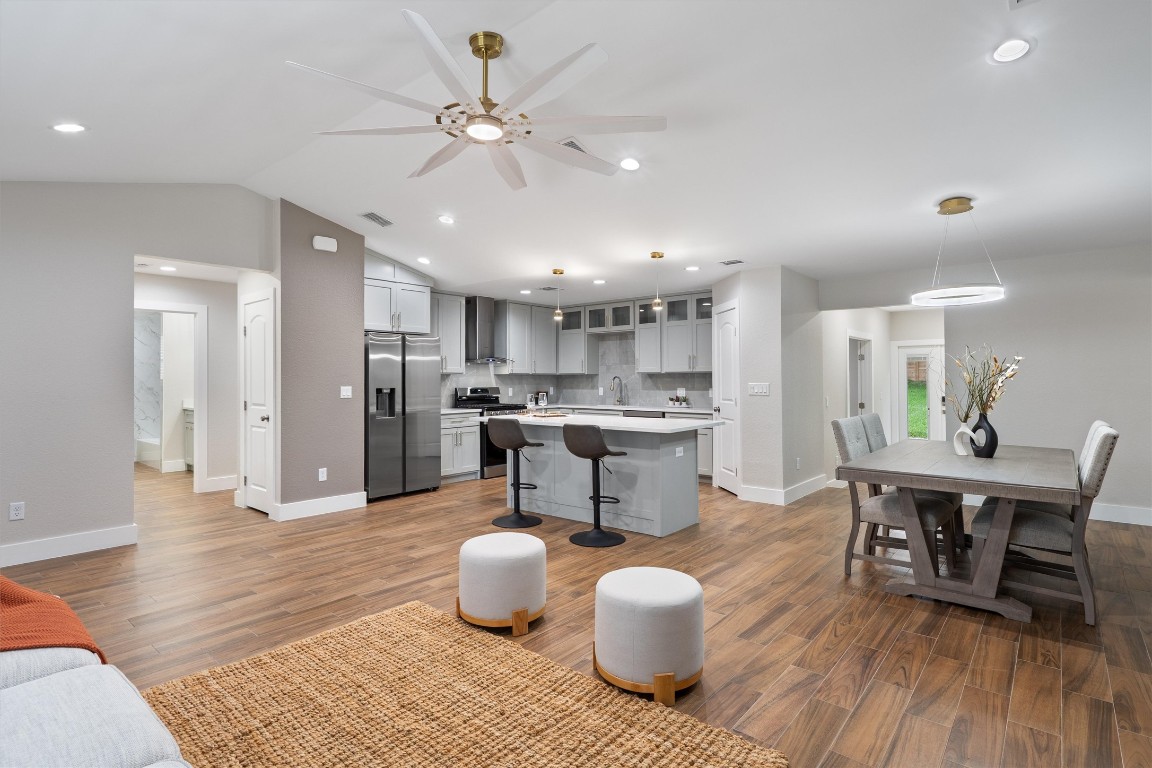 803 Glen Road Austin, TX 78753 - Photo 7 of 35 a living room with stainless steel appliances kitchen island granite countertop furniture wooden floor and a view of kitchen