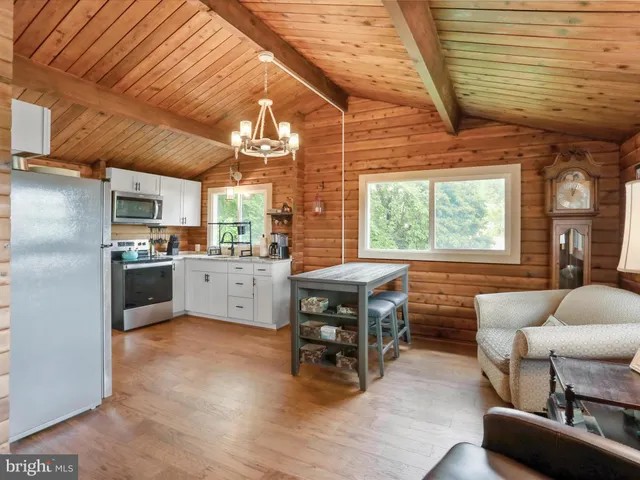 a kitchen with furniture a counter top space a sink stainless steel appliances and cabinets