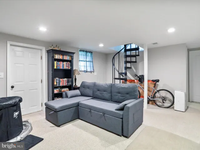 a living room with furniture a couch and a window