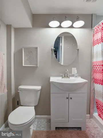 a bathroom with a toilet sink and mirror