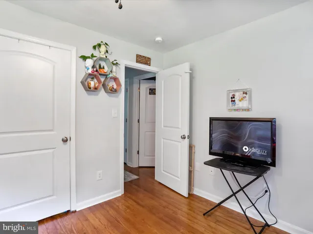 a view of play room with toys and wooden floor