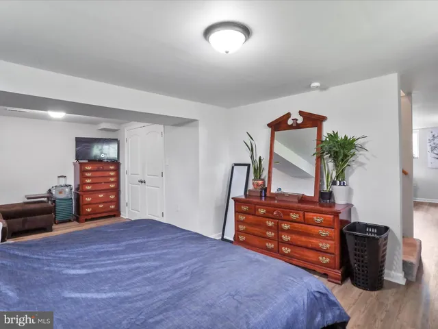 a living room with furniture and a dresser