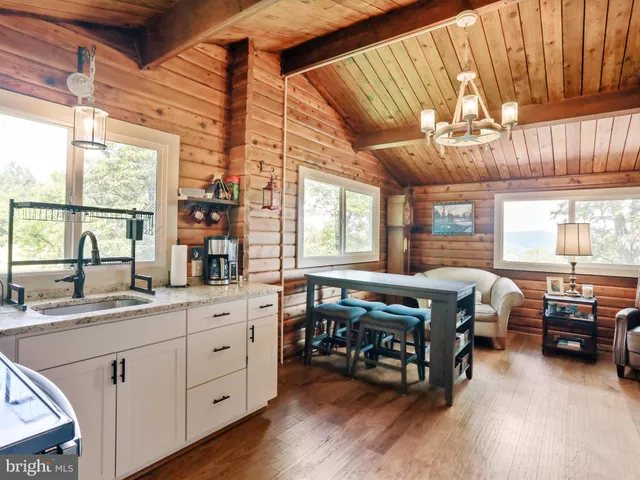a large bedroom with a bed and a large window with wooden floor