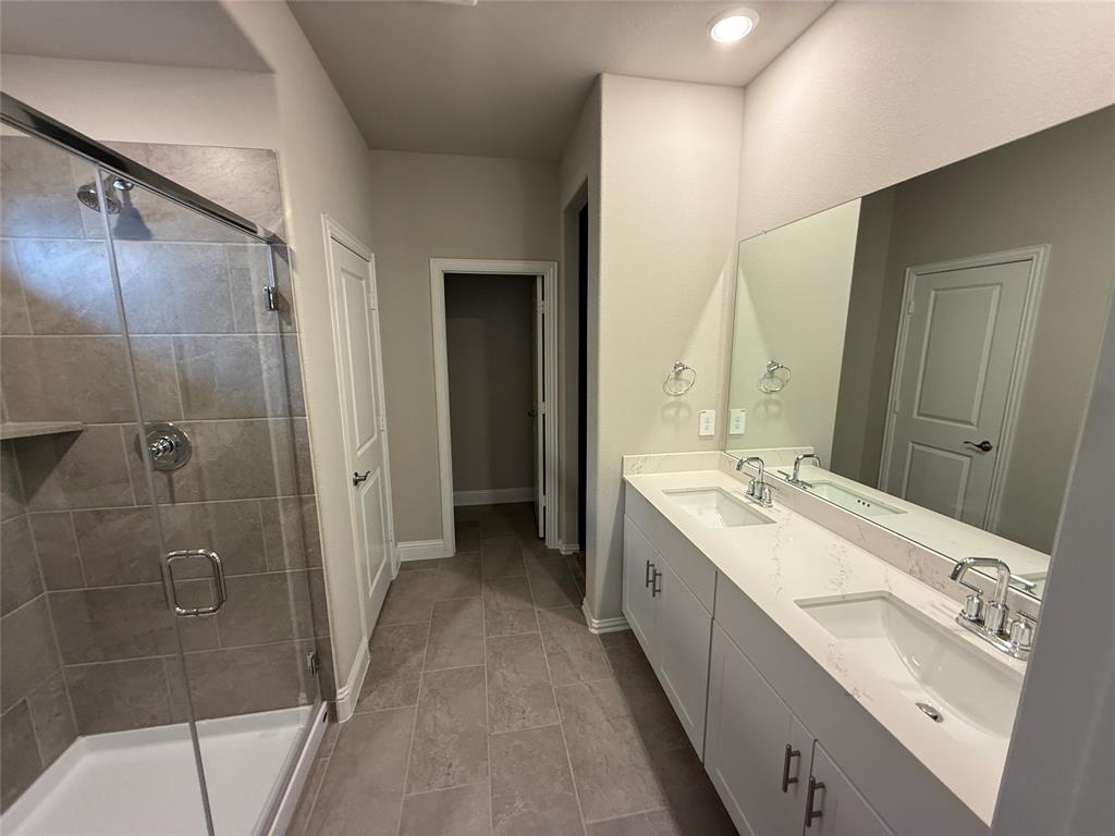 702 Williams Way Lowry Crossing, TX 75069 - Photo 18 of 22 a bathroom with a double vanity sink mirror and shower