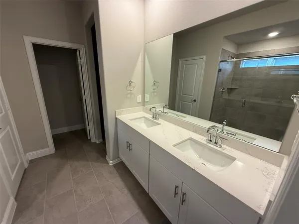 a bathroom with a double vanity sink mirror and double
