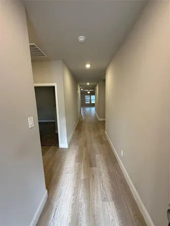 a view of gallery with wooden floor