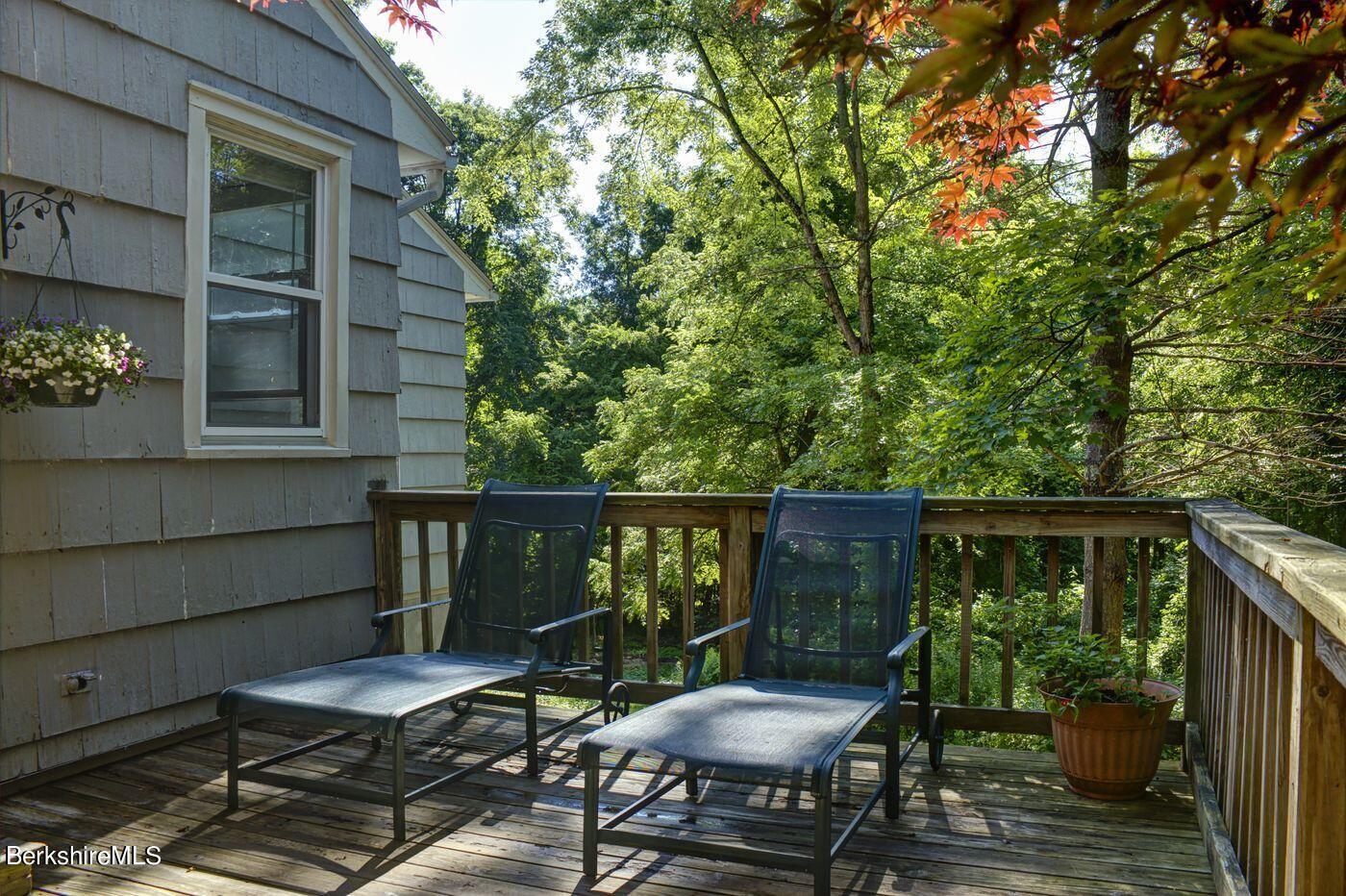 58 Interlaken Road Stockbridge, MA 01262 - Photo 13 of 15 a view of a balcony with chairs and wooden fence