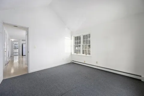 an empty room with a empty space and a window