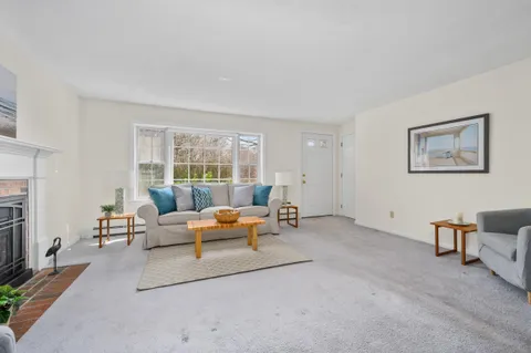 a living room with furniture and a kitchen