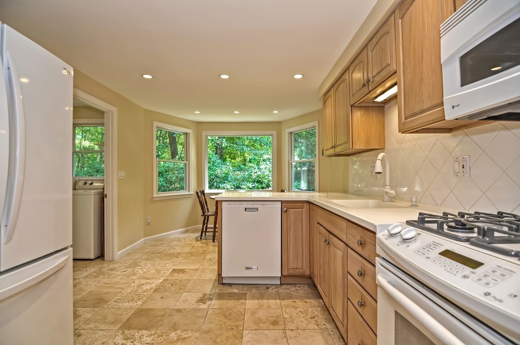 948 Salem End Road Framingham, MA 01702 - Photo 11 of 23 a kitchen with a stove a sink and a refrigerator