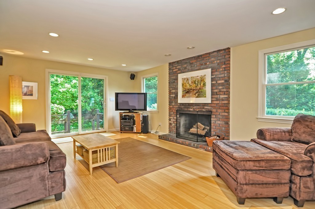 948 Salem End Road Framingham, MA 01702 - Photo 10 of 23 a living room with furniture a fireplace and a large window