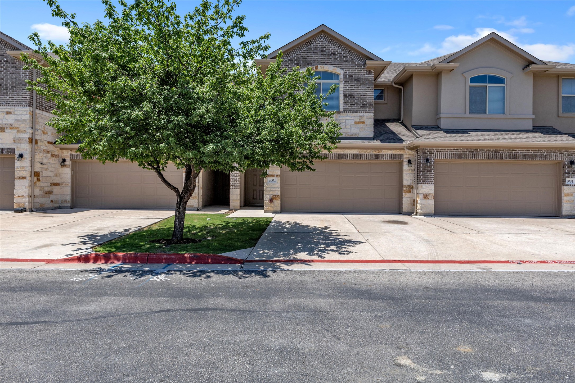 2880 Donnell Drive, Unit 2003 Round Rock, TX 78664 - Photo 1 of 31 Townhome exterior featuring a combination of stone, brick, and stucco finishes